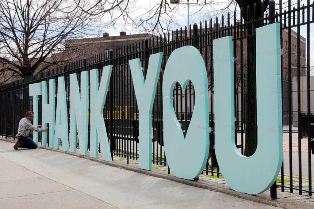 Scott LoBaido finishing Thank You installation at hospital